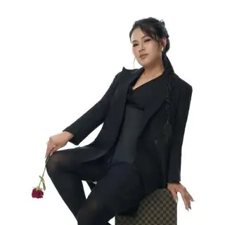 Mary-June HK seated with a single red rose