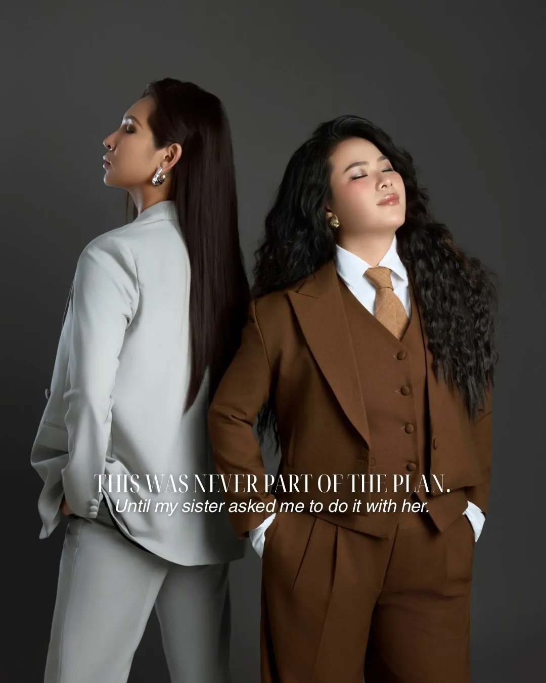 Mary-June and her sister Tiffany, back to back in tailored suits